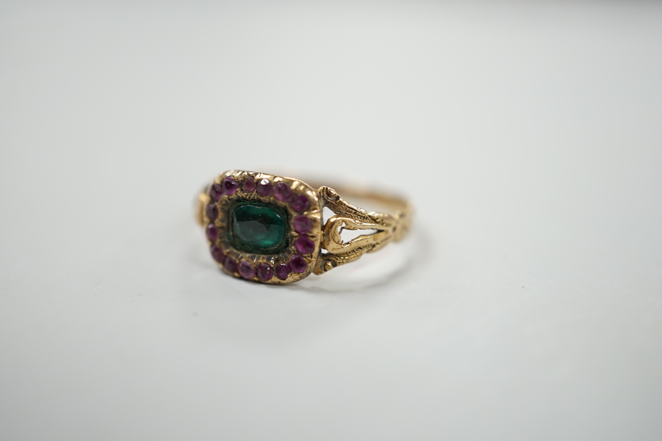 A 19th century yellow metal and two colour garnet? cluster set dress ring, size J, gross weight 1.6 grams.